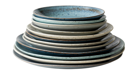 A beautifully arranged stack of rustic handmade ceramic tableware, including plates and a bowl in various shades of blue and grey, isolated on a clean white background