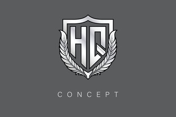 HQ Creative Initial Letter Logo with Shield and Laurel Wreath Silver Metallic Branding Emblem on Gray Background.
