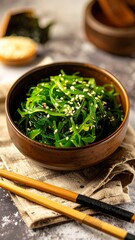 Close-up view of a vibrant seaweed salad, dressed with sesame seeds, served in a rustic brown bowl.