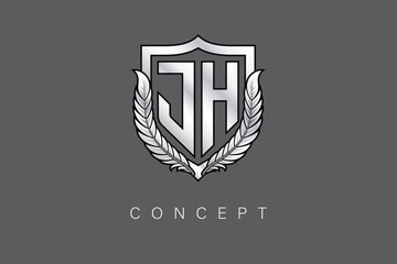 JH Creative Initial Letter Logo with Shield and Laurel Wreath Silver Metallic Branding Emblem on Gray Background.
