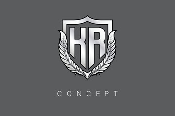 KR Creative Initial Letter Logo with Shield and Laurel Wreath Silver Metallic Branding Emblem on Gray Background.