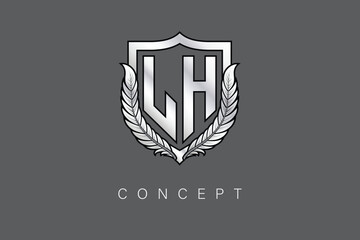 LH Creative Initial Letter Logo with Shield and Laurel Wreath Silver Metallic Branding Emblem on Gray Background.