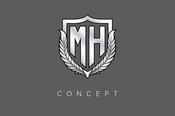 MH Creative Initial Letter Logo with Shield and Laurel Wreath Silver Metallic Branding Emblem on Gray Background.