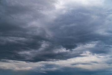 the dark clouds make the sky in black. The rain is coming soon.