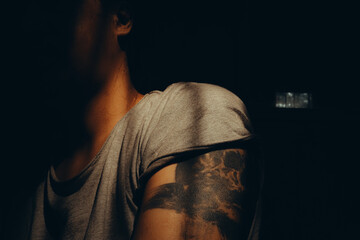Tattooed Man with Dramatic Low Light Shadows on Arm