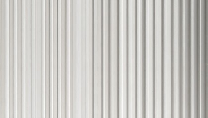 Obraz premium A close-up view of a smooth, white surface with vertical, linear grooves creating a subtle textured effect.