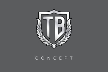TB Creative Initial Letter Logo with Shield and Laurel Wreath Silver Metallic Branding Emblem on Gray Background.