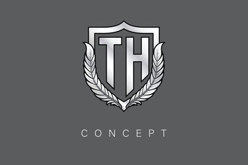 TT Creative Initial Letter Logo with Shield and Laurel Wreath Silver Metallic Branding Emblem on Gray Background.
