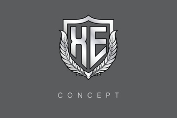 XE Creative Initial Letter Logo with Shield and Laurel Wreath Silver Metallic Branding Emblem on Gray Background.