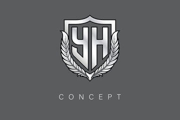 YH Creative Initial Letter Logo with Shield and Laurel Wreath Silver Metallic Branding Emblem on Gray Background.