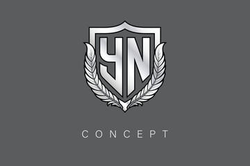 YN Creative Initial Letter Logo with Shield and Laurel Wreath Silver Metallic Branding Emblem on Gray Background.