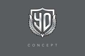 YO Creative Initial Letter Logo with Shield and Laurel Wreath Silver Metallic Branding Emblem on Gray Background.