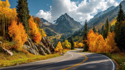 Scenic mountain road winding through vibrant autumn foliage.