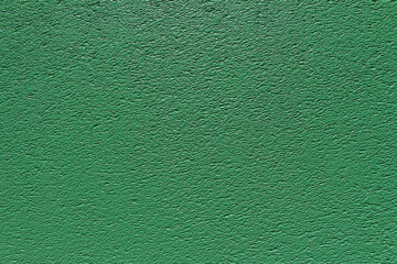 Rough surface of green concrete wall close up background. Uneven cement wall texture.