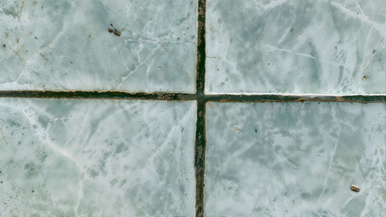 Close-Up of Aged Ceramic Tile Surface with Dark Grout Lines