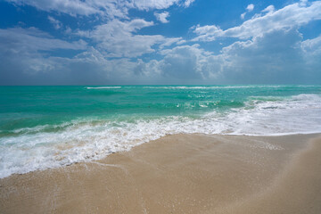 Tropical coastline. Exotic sea beach destination. Foamy sea beach waves. Sunny sea beach holiday. Relaxing sea beach vacation.