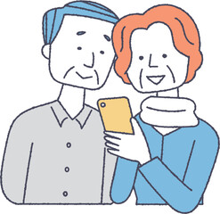 スマホを見ているシニア夫婦