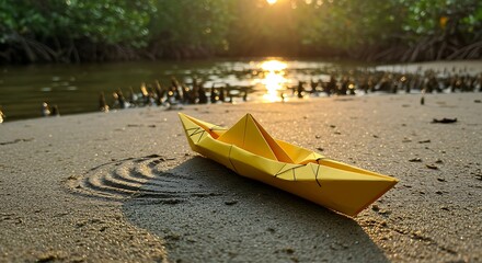 Yellow Origami Boat on Sand at Sunset
