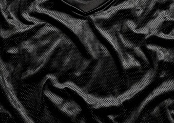 Close-up of a black, textured, athletic top.  Wrinkled fabric with a mesh pattern