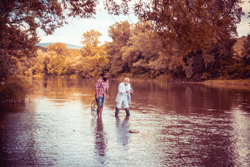Fototapeta premium Mature senior man with friend fishing. Summer vacation. Happy cheerful people. Bearded men catching fish. Fisherman with fishing rod. Activity and hobby.