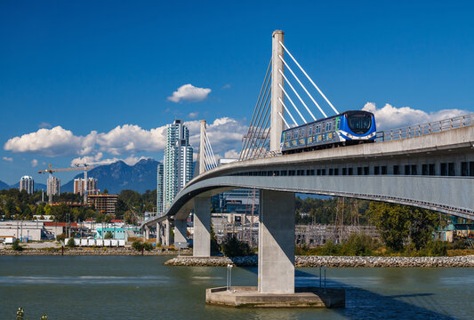 VANCOUVER, CANADA &ndash; AUGUST 11, 2016: Canada line train passes bridge on August 11, 2016. The Canada Line is Vancouver&rsquo;s new rapid transit rail link connecting airport to downtown Vancouver.