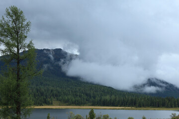 Serene Mountain Landscape with Cloud Cover and Tranquil Lake