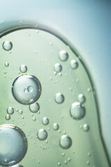 A macro abstract image of oil bubbles suspended in clear liquid, evoking facial serum texture. Ideal for beauty, cosmetic, and skincare-themed visuals.