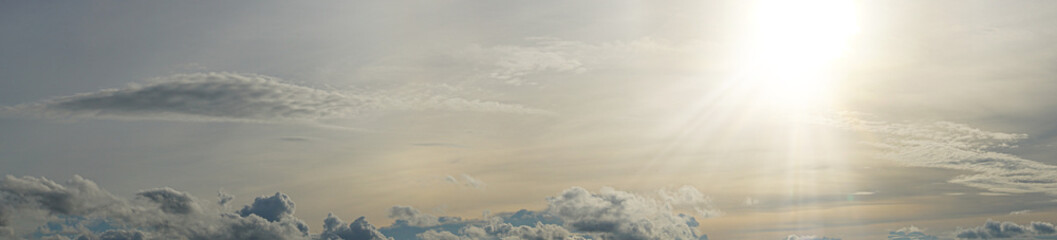 Fototapeta premium Background and texture of panorama view. Landscape of evening sky with floating clouds and warm sunlight.