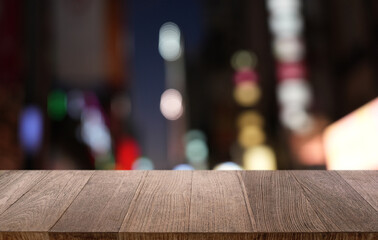 Empty wood table top and blur of restaurant background selective focus product display