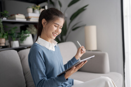 Asian woman Graphic designer working on digital tablet. artist drawing on graphic tablet female Artist Creative Designer sketch graphic drawing creative studying work on tablet at home