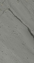 A close-up view of a textured gray surface with diagonal lines and cracks, showcasing a rough, uneven, and mottled pattern.