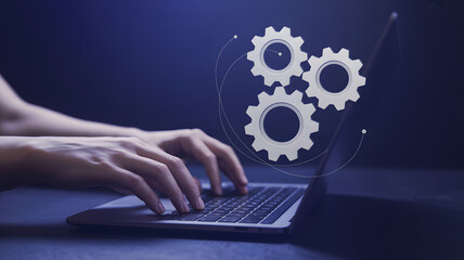 Hands type on laptop with gear graphic overlay, automation concept