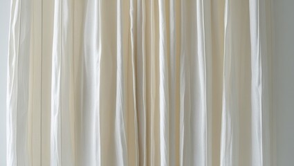 Obraz premium Pleated cream-colored curtains, displaying subtle folds and soft light.