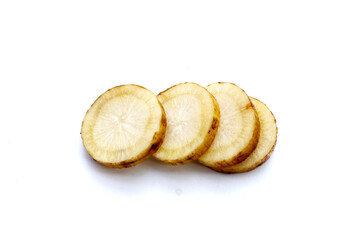 Fresh burdock root slices (gobo root) on white background.
