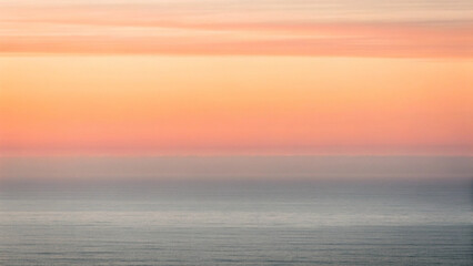 Fototapeta premium Soft Focus Ocean Horizon with Warm Orange and Pink Sunset Sky water