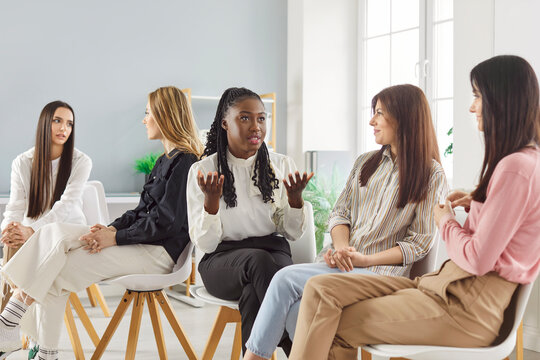 Female community conversation, young girls gathering in club discussing, best female friends, multiracial group, women entrepreneurs, leaders, founders of startup, mental health group therapy meeting - Powered by Adobe