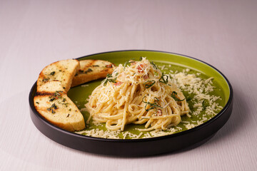 Plate of Carbonara Pasta on a Green Plate