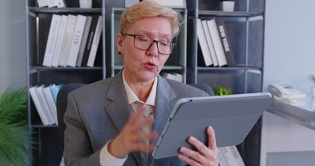 Businesswoman making video call online using tablet web camera, coach looking and talking, mentor speaker explaining, giving consultation, internet advice or guidance, participate in interviewing - Powered by Adobe