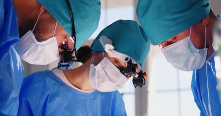 Team of skilled surgeons focuses intently on crucial surgical procedure in modern operating room. Doctors in sterile clothing use precise instruments and advanced technology in their work. - Powered by Adobe