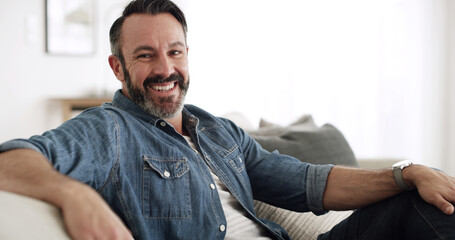 Fototapeta premium Portrait, man and relax with smile at house for peace, start day and comfortable of weekend break. Happy, mature male person and chilling on couch for free time, cozy homeowner and unwind of wellness