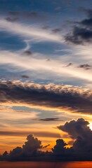 Fototapeta premium Dramatic Sunset Sky with Fiery Clouds and Golden Hues.
