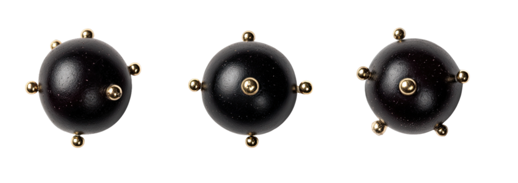 Three dark spheres, each with gold studs