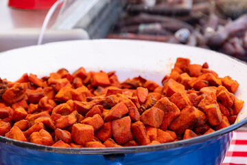 Spicy fried pork cubes in enamel bowl.