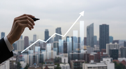 Hand drawing a rising financial graph with an arrow pointing upwards over a modern city skyline background symbolizing growth