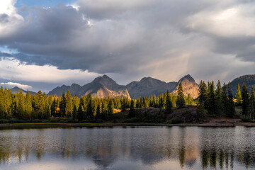 Fototapeta premium Sunset over the mountains by the lake