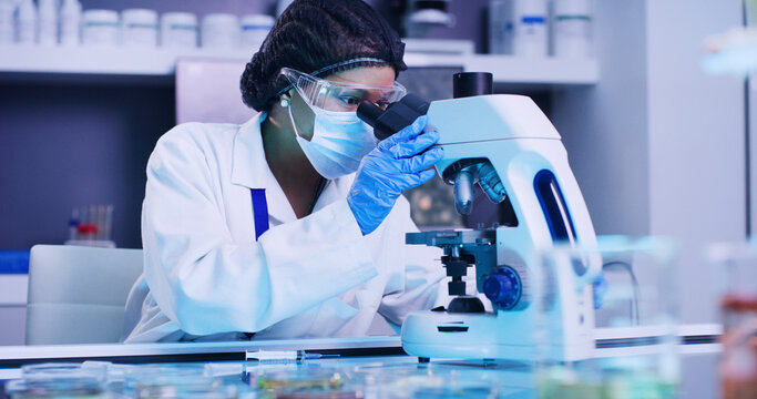 Woman, scientist and check with microscope in lab for research, medical experiment and testing dna. Female person, face mask and sample analysis, genetic engineering and studying virus for biotech