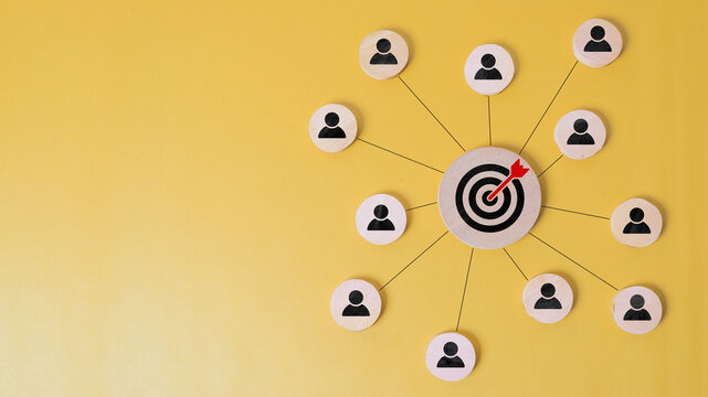 Customer relationship management concept. wooden block with target icon linked with human icons for customer focus group. Data exchanges development and customer service