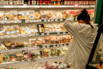 A Shopper's Dilemma: Choosing from a Colorful Array of Prepared Meals and Snacks in a Grocery Store Aisle