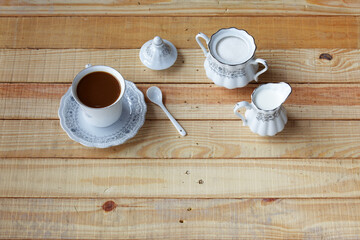 Elegant White Tea Set with Coffee, Sugar, and Creamer on Wood Table