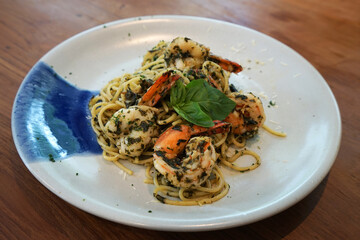 Close up plate of Spaghetti pasta with shrimp Pesto sauce